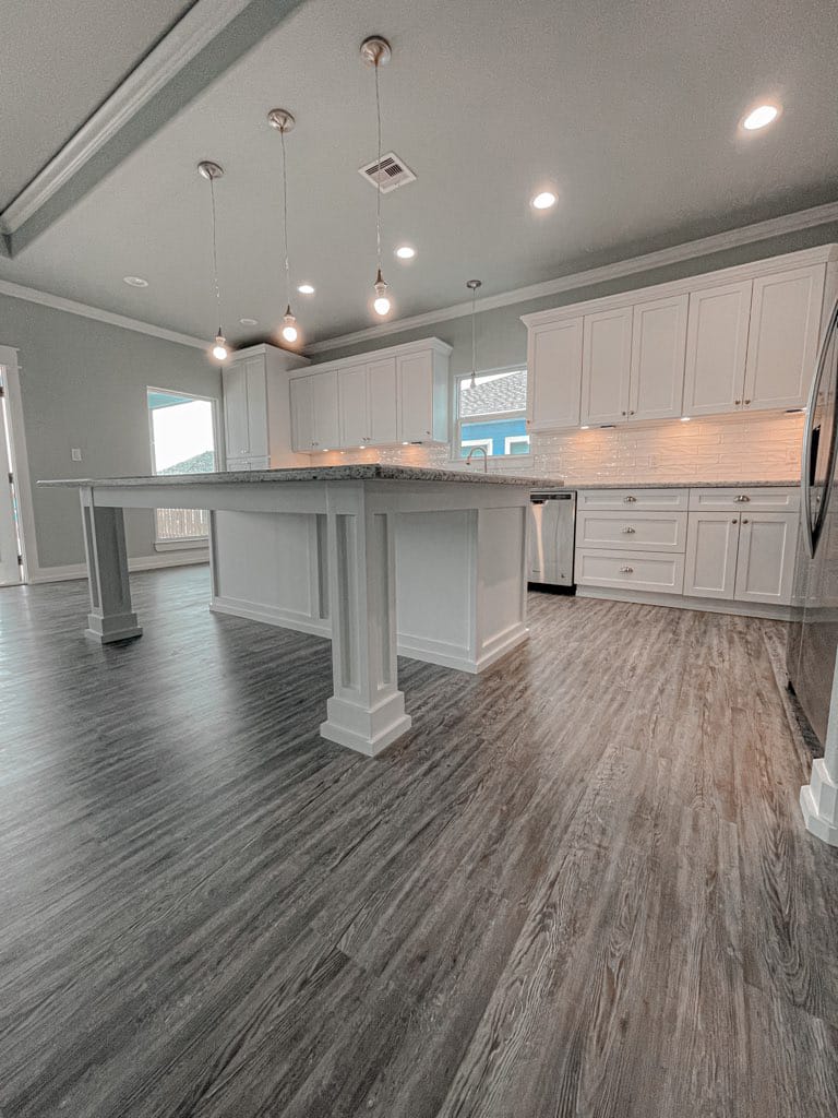 Completed kitchen remodel with white shaker cabinets and new flooring